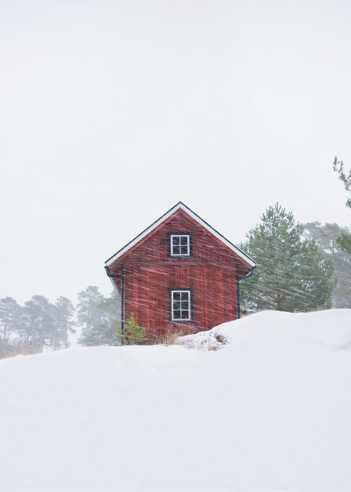Old red house during snowstorm | Canvas